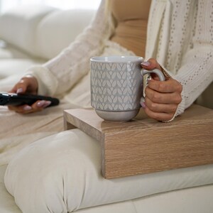 Sofa arm tray table made from solid white oak fits over the arm of your couch to create a convenient and sturdy surface for daily use perfect for holding snacks coffee remotes or a phone this wood couch side table adds function and style to compact living spaces with a clean natural finish