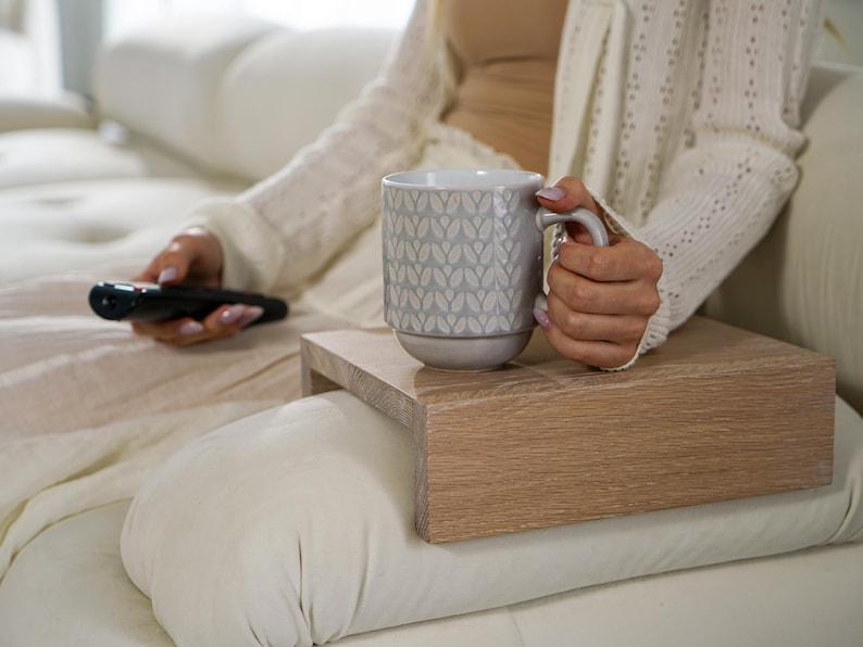 Sofa arm tray table made from solid white oak fits over the arm of your couch to create a convenient and sturdy surface for daily use perfect for holding snacks coffee remotes or a phone this wood couch side table adds function and style to compact living spaces with a clean natural finish