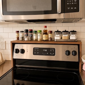 Modern walnut over stove shelf for kitchen organization handmade from hardwood with a sleek low profile design that adds extra storage above the stove for spice jars cooking oils seasonings and decorative kitchen accessories