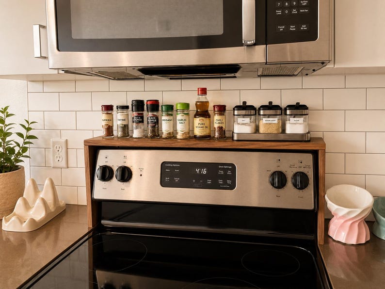 Modern walnut over stove shelf for kitchen organization handmade from hardwood with a sleek low profile design that adds extra storage above the stove for spice jars cooking oils seasonings and decorative kitchen accessories