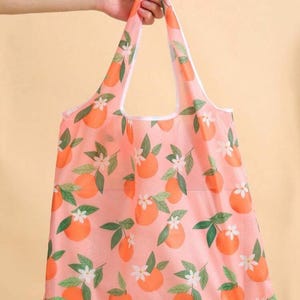 Bolsa de compras grande, plegable y reutilizable, ecológica, portátil, con diseño impreso, sostenible y compacta.