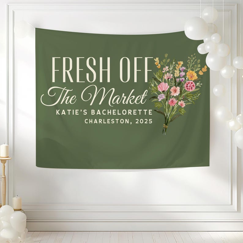 May include: Green banner with white text that reads "Fresh Off The Market" and "Katie's Bachelorette Charleston, 2025". A bouquet of pink, yellow, and purple flowers is on the right side of the banner.