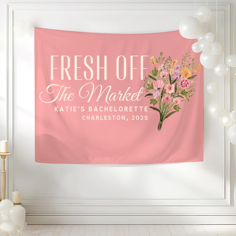 May include: Pink bachelorette party backdrop with the text "Fresh Off The Market" and a floral bouquet. The text also includes "Katie's Bachelorette Charleston, 2025".