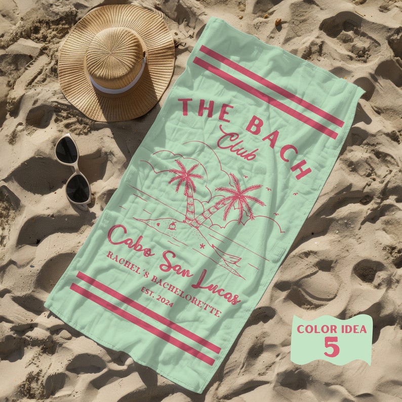 May include: A mint green beach towel with the text "THE BACH Club" and "Cabo San Lucas" in pink. The towel also features a palm tree design and the text "Rachel's Bachelorette Est. 2024".