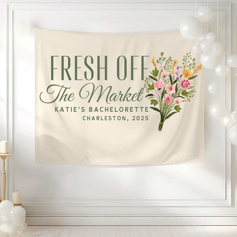 May include: A beige banner with the text "Fresh Off The Market" in green lettering. Below the text is "Katie's Bachelorette Charleston, 2025". A bouquet of pink, yellow, and white flowers with green leaves is on the right side of the banner.