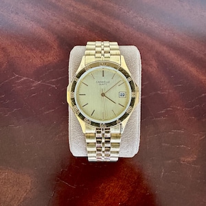 Orologio vintage Caravelle di Bulova in oro con giorno e data, numeri romani, testato