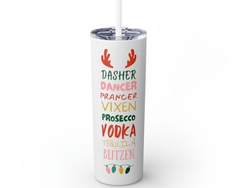 May include: White tumbler with a red and green Christmas design. The tumbler has the words "Dasher, Dancer, Prancer, Vixen, Prosecco, Vodka, Tequila, Blitzen" printed on it.