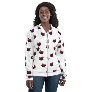 May include: A white bomber jacket with a black and red cat pattern. The cat has a red bandana on its head.