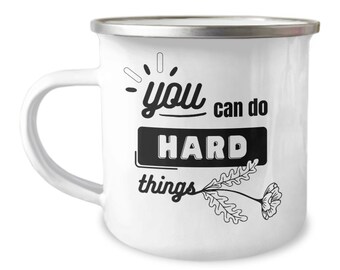 May include: White enamel mug with a black graphic that says "you can do hard things" with a stylized flower and leaves.