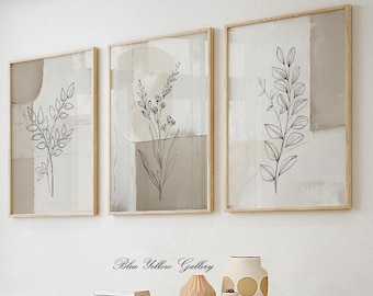 May include: Three framed botanical art prints. Each print features a black line drawing of a plant against a neutral background with beige and gray geometric shapes. The frames are light wood. The text "Blue Yellow Gallery" is below the prints.