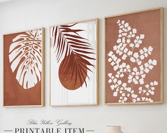 May include: Set of three printable wall art prints featuring abstract botanical illustrations in shades of brown and white. The prints feature a palm leaf, a monstera leaf, and a fern. The text "Blue Yellow Gallery - PRINTABLE ITEM" is at the bottom of the image.