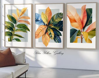 May include: Three framed prints of tropical leaves in shades of green, yellow, orange, and blue. The prints are arranged in a row on a white wall.