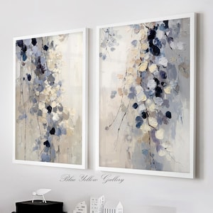 May include: Two framed abstract paintings with white frames. The artwork features a floral design in shades of blue, cream, and gray. The text "Blue Yellow Gallery" is at the bottom of the image.