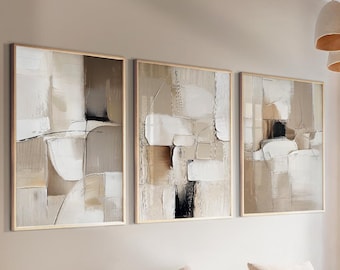 May include: Three framed abstract art pieces with neutral tones of beige, white, and black. The artwork features geometric shapes and textures, creating a modern and minimalist aesthetic. The frames are a light wood color.