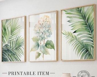 May include: Three framed watercolor prints featuring botanical illustrations. The prints are in a minimalist style with a white background and feature a hydrangea, a palm leaf, and a tropical leaf.