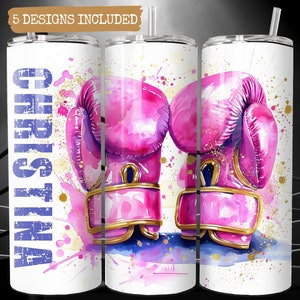 May include: A white tumbler with a watercolor design of pink boxing gloves and gold accents. The tumbler has the name "Christina" written in blue on the side.