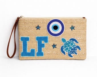 Beige woven clutch holiday beach club initials personalised ibiza vibes party bag patches evil eye sea star fish turtle print blue greece