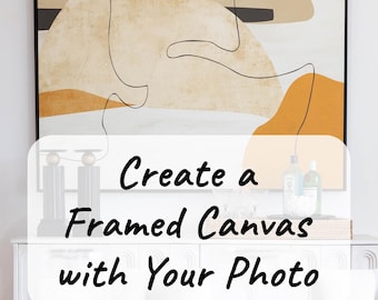 May include: Create a Framed Canvas with Your Photo. A framed canvas with an abstract design in shades of brown, orange, and black. The canvas is hanging on a white wall above a white dresser.