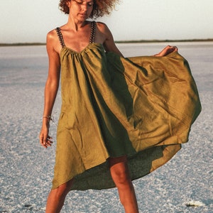 This stunning Irazu dress is hand made in Bulgaria from 100% natural linen fabric. 
It features a unique design with a shorter length in the front and longer length in the back. This dress is available in many beautiful colours.