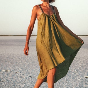 This stunning Irazu dress is hand made in Bulgaria from 100% natural linen fabric. 
It features a unique design with a shorter length in the front and longer length in the back. This dress is available in many beautiful colours.