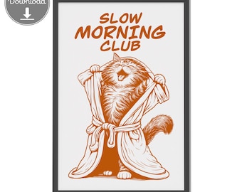 Può includere: Stampa artistica incorniciata con un gatto dei cartoni animati con un accappatoio e sorridente. Il testo "SLOW MORNING CLUB" è sopra il gatto. L'opera d'arte è nei toni del marrone e del bianco, con uno stile minimalista.