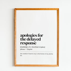 May include: A framed print with the text "apologies for the delayed response" and a phonetic pronunciation of the phrase. The text also includes the definition of the phrase as "this somehow found its way to the bottom of my priority list."