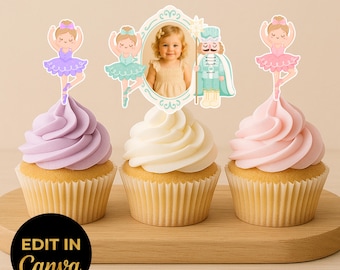 May include: Three cupcakes with pastel frosting and decorative toppers. One cupcake has lavender frosting and a ballerina topper. Another has white frosting and a photo frame topper. The last has pink frosting and a ballerina topper. The cupcakes sit on a wooden board.