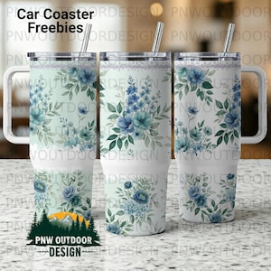 May include: Three white travel mugs with floral designs. The mugs feature blue and teal flowers with green leaves. Each mug has a silver straw and a white handle. The text "Car Coaster Freebies" is at the top.