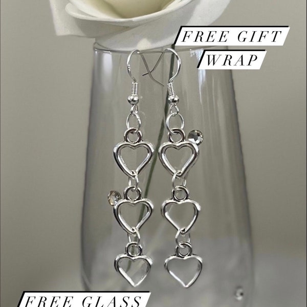 Silver triple heart drop earrings. Sterling silver ear hook with a trio of heart pendants. Free gift wrapping to make the perfect gifts.