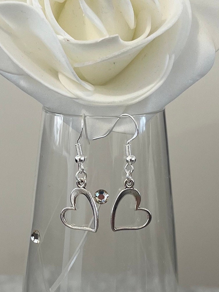 Tiny Silver heart earrings. Sterling silver ear hook with dainty heart drop. Free gift wrapping to make the perfect little gift.