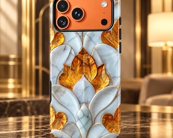 May include: A smartphone case featuring a white marble-like pattern with gold leaf-shaped accents. The camera module area is a solid orange color with three circular lenses and a flash. The design has a layered, embossed appearance.