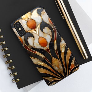 May include: A black phone case with a gold and brown stained glass design featuring stylized flowers.