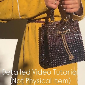 May include: A beaded handbag in shades of purple and black, with a gold chain detail and a drawstring closure. The bag is held by a person wearing a yellow dress. Text on the image reads "Detailed Video Tutorial (Not Physical item)".