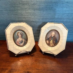 May include: Two antique portrait miniatures in octagonal frames with gold accents. The frames are made of white bone with a tortoiseshell inlay. The portraits are of a woman and a man in period clothing.