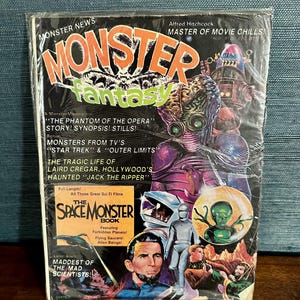 May include: A vintage "Monster Fantasy" magazine, featuring colorful illustrations of monsters, aliens, and science fiction themes. The cover includes text such as "The Space Monster Book" and "Alfred Hitchcock: Master of Movie Chills!"