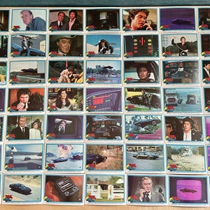 May include: A white ceramic mug with a black handle and the text "But First, Coffee" in a handwritten style. The mug is on a white surface. The mug is approximately 4 inches tall.