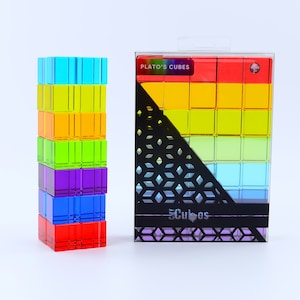May include: A set of brightly coloured, transparent cubes, stacked and boxed. The cubes are in rainbow colours: red, orange, yellow, green, blue, and purple. The box is labelled "PLATO'S CUBES" and "CMY Cubes".