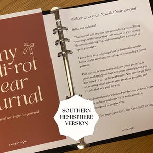 May include: Open journal with the title "my anti-rot year journal" in a dark red cover. The journal is open to a page with text and a metal binder. The text "SOUTHERN HEMISPHERE VERSION" is also visible.