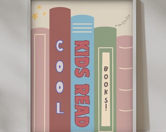 May include: A framed print with a colorful illustration of stacked books. The books are labeled "KIDS READ" and "COOL BOOKS!" with stars and paper airplanes in the background.