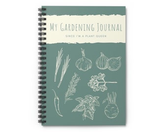 May include: A green spiral bound journal with the text "My Gardening Journal Since I'm a Plant Queen" on the cover. The cover is decorated with white line drawings of various herbs and vegetables, including garlic, chives, parsley, basil, and figs.