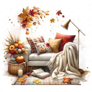 May include: A white couch with a white throw blanket and pillows in shades of red, brown, and beige. The couch is decorated with fall leaves and a pumpkin. A book is on the floor in front of the couch.