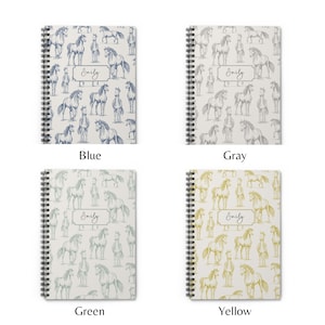 May include: Four spiral bound notebooks with a horse illustration pattern. The notebooks are in blue, gray, green, and yellow. The name "Emily" is printed on each notebook.
