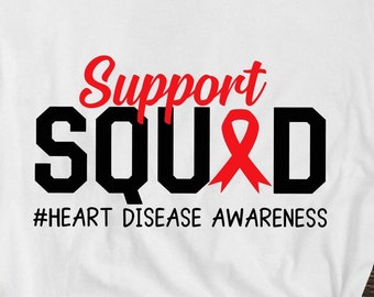 May include: White t-shirt with black text that reads "Support SQUAD" with a red ribbon in the middle of the word "SQUAD". The text below reads "#HEART DISEASE AWARENESS".