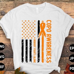 May include: A white t-shirt with an orange ribbon and an American flag design. The text "COPD AWARENESS" and "NOBODY FIGHTS ALONE" are printed on the shirt.