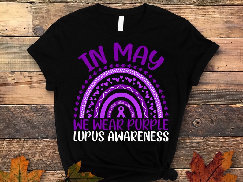 May include: Black t-shirt with a purple rainbow and hearts, and the text "In May We Wear Purple Lupus Awareness".