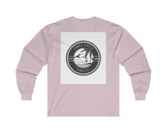 May include: A pink long-sleeve t-shirt with a white square on the back featuring a black and white logo that says "Three Little Birds Co. Est. 2008" with a palm tree and birds graphic.