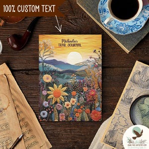 May include: A personalized trail journal with a colorful floral design and a sunset landscape. The cover reads "Michaela's Trail Journal".