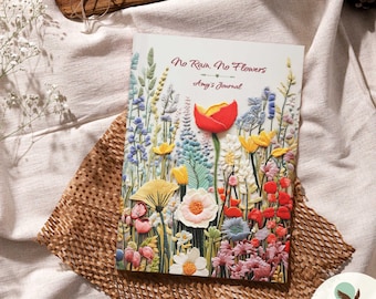 May include: A colorful journal with a floral design and the text "No Rain, No Flowers Amy's Journal".