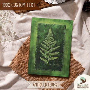 5 of 5 Forest aesthetic journal gifts for hikers, her or him. This woodland notebook is called Antiqued Ferns and is displayed on a beige outdoor picnic blanket. A rustic forest green ferns journal that is perfect for family camping memories, hiking adventures and forest lovers of all ages.