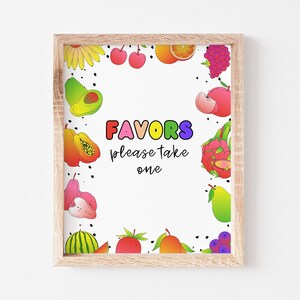 May include: A printable sign with a white background and a colorful border of fruit illustrations. The sign says "Favors please take one" in rainbow letters.